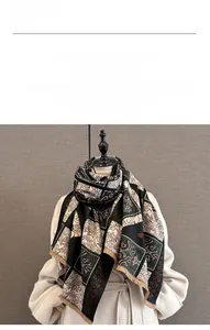 Close-up of vintage cashmere-like scarf showing intricate floral textures and soft fringe
