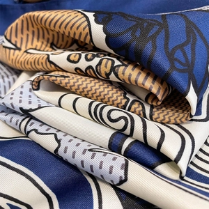 Macro shot showing the premium silk twill texture and vintage floral print pattern detail