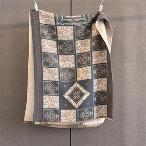 Detail of vintage geometric jacquard pattern and soft fringe on cashmere-like shawl