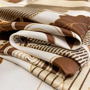 Detailed macro view of retro floral print silk scarf with fine twill texture and luster