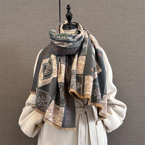 Detail of vintage cashmere-like jacquard scarf with geometric patterns and fringe edges