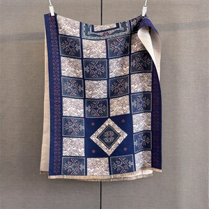Detailed texture of vintage geometric jacquard scarf with light cream tassel fringe