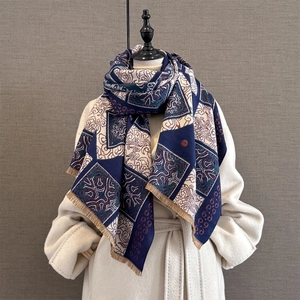 Detail of vintage cashmere-feel scarf with geometric patterns and fringe edges