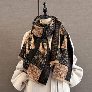 Detailed texture of a vintage plaid shawl with intricate floral patterns and soft tassels