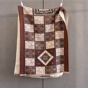 Close-up of vintage geometric grid jacquard scarf with decorative fringe details