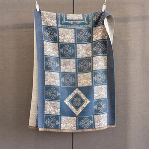Detail of vintage geometric jacquard woven scarf with elegant blue tassels