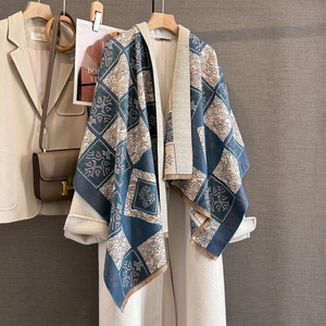 Detail of vintage plaid jacquard scarf with fringe and floral pattern on a white coat