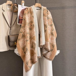 Detailed view of vintage geometric cashmere-feel scarf with clouds pattern and tassels