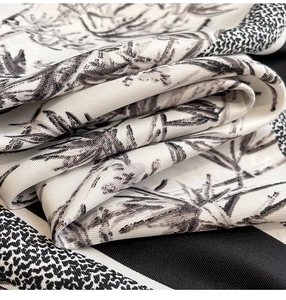 Detail shot of the bamboo leaf print on luxury silk scarf showing twill texture