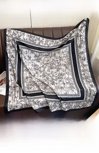 Detail of silk-like bamboo leaf print scarf showing ink wash pattern on leather surface