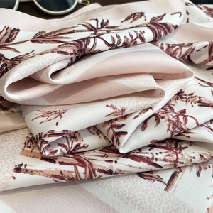 Close-up of bamboo leaf print silk scarf texture with sunglasses for styling