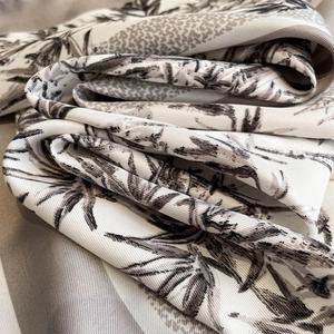 Detailed close-up of bamboo leaf printed twill silk scarf with fine texture and black and white pattern