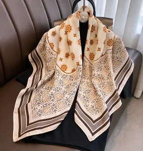 Close-up of elegant floral print scarf with silk texture and camellia flower brooch