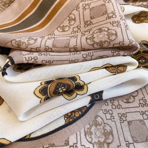 Detailed macro shot of vintage floral pattern and twill weave texture on a silk scarf