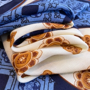 Macro shot of fine twill texture and vintage floral patterns on a soft silk scarf
