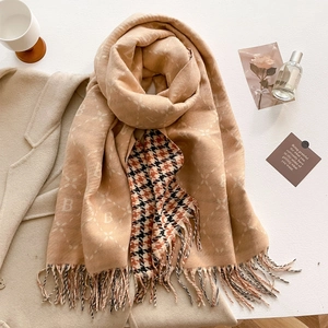 Detailed view of the soft faux cashmere scarf with letter B pattern and plaid elements