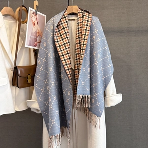 Detail of cashmere-like scarf with letter B pattern and houndstooth check tassel design
