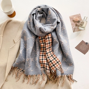 Thick light blue cashmere-like scarf with letter B jacquard pattern and fringes