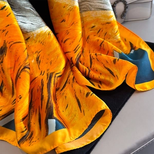 Silk-like scarf featuring Van Gogh sunflower print and elegant black-orange color block