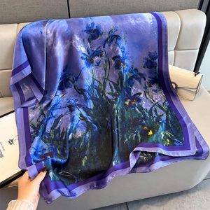 Artistic van Gogh iris print silk scarf in blue and purple displayed on leather sofa