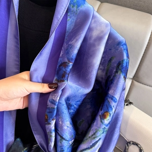 Purple satin silk scarf for women featuring blue floral print patterns in a soft drape style