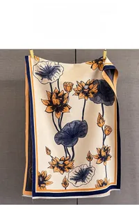 Detail of lotus jacquard pattern on a thick faux cashmere scarf with frayed edges