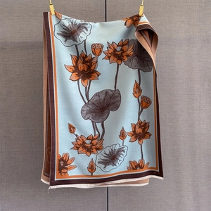 Detail of blue lotus scarf showing jacquard pattern and fine tassel fringe craftsmanship