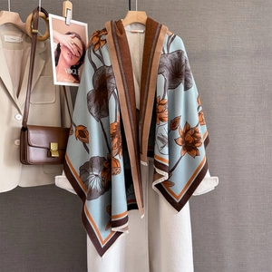 Winter faux cashmere scarf with lotus print and contrasting border on beige coat