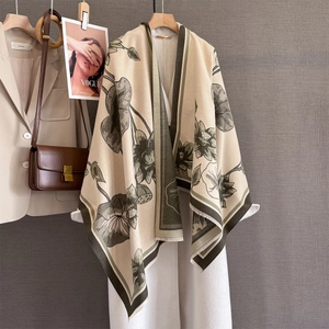 Detail of elegant lotus pattern on beige shawl with fringe and vintage floral print
