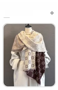 Detailed view of imitation cashmere scarf with contrast floral pattern and short fringe