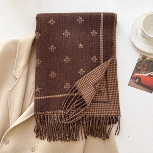 Brown knit scarf with bee jacquard and star patterns featuring classic tassels