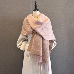 Detail of bee jacquard pattern and long fringes on thick pink and brown scarf