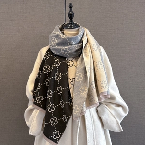 Detail of multi-color winter scarf with clover pattern and delicate short fringe