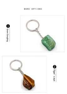 Detail of raw Tiger's Eye and Green Aventurine gemstones on silver metal keychains