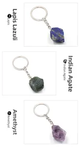 Close-up of raw rose quartz and amethyst natural crystal stones on silver keyrings