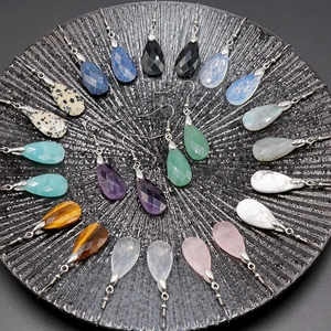 Natural faceted crystal teardrop earrings in various gemstones arranged in a circular display
