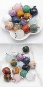 Macro shot of assorted colorful apple-shaped gemstone pendants with silver leaf bails