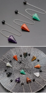 Radial display of hexagonal crystal pendulums in amethyst, rose quartz, and tiger eye