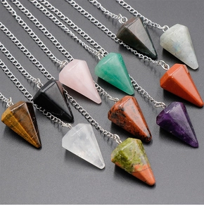Macro shot of assorted hexagonal crystal gemstone pendants with silver chain details
