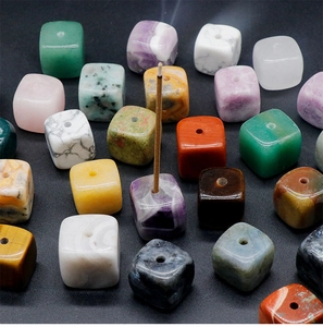 Detailed close-up of natural crystal cubes used as incense holders on black background