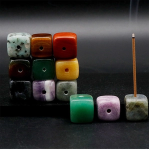 Macro detail of natural stone cubes for incense sticks on a dark background