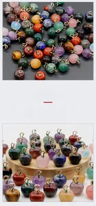 Macro detail of various apple-shaped crystal pendants on a wooden display stand