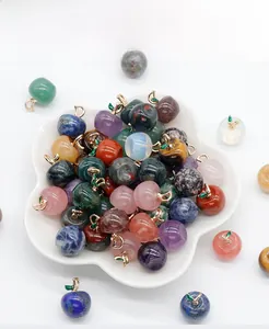 Macro shot of assorted apple-shaped natural stone pendants with gold leaf detailing