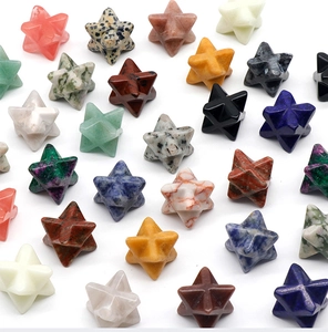 Flat lay of colorful 30mm natural crystal Merkaba stars in assorted semi-precious stones