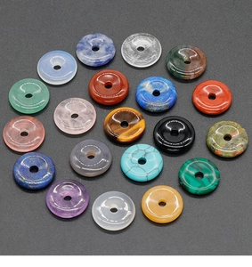 Top view of 18 colorful natural stone donut pendants for DIY jewelry making and crafts