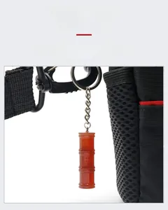 Detail of red carnelian bamboo-shaped pendant attached to a bag as a key ring accessory