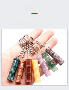 Detailed view of bamboo-shaped natural crystal keychains in seven various gemstone colors