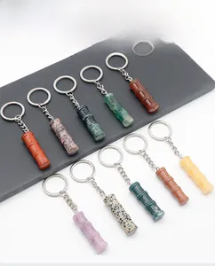 Detailed view of bamboo-shaped natural crystal and gemstone keychains in ten various colors