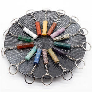 Macro shot of colorful natural crystal bamboo-shaped keychains in various gemstones