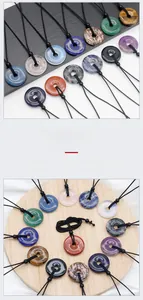 Detailed view of various natural crystal donut pendants with braided cords on stone base
